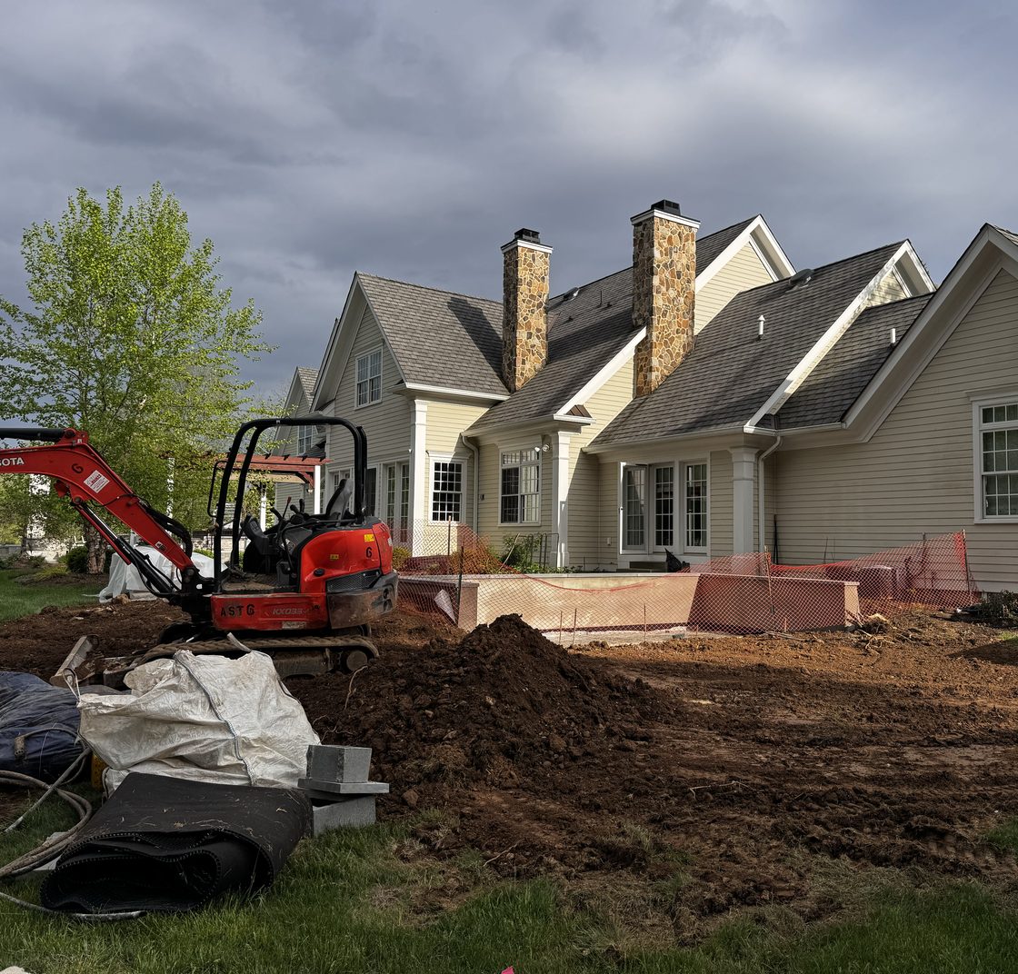 Homeowner backyard project in progress with a mini excavator